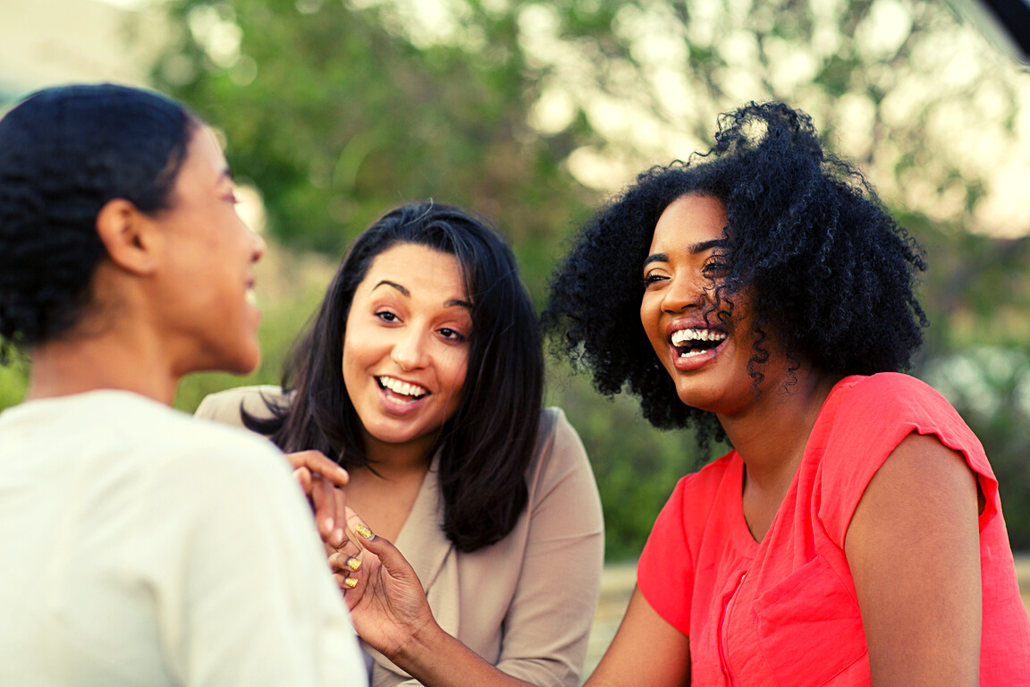 Multi-ethnic group of women laughing and talking.